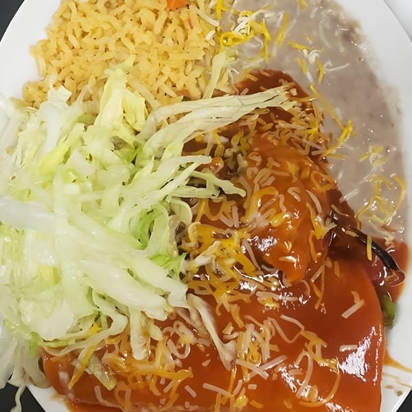 Albertano's Mexican food plate with chile relleno, rice, refried beans, shredded lettuce, and cheese.